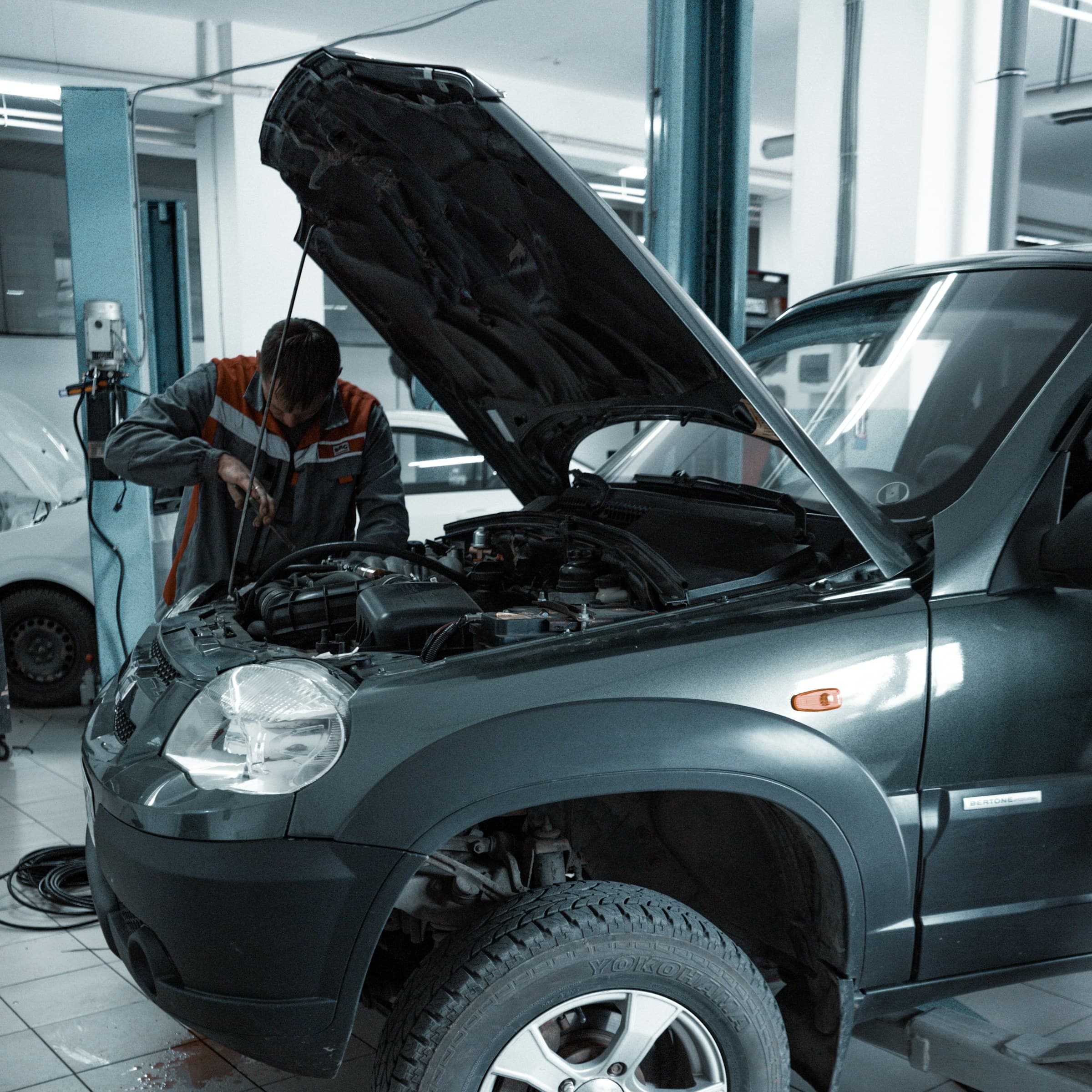 Clean auto repair service bay with lifts and equipment